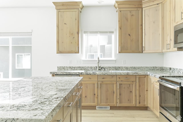 4728 E Lake Corner Dr, Eagle Mountain, UT 84005 - kitchen with appliances with stainless steel finishes, light brown cabinetry, light wood finished floors, and light stone counters