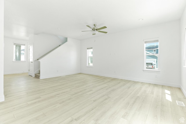 4728 E Lake Corner Dr, Eagle Mountain, UT 84005 - unfurnished living room with a ceiling fan, stairs, and light wood-style flooring