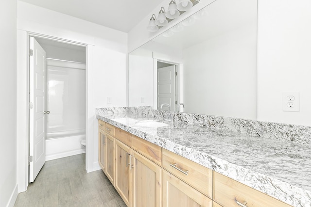 4728 E Lake Corner Dr, Eagle Mountain, UT 84005 - bathroom with vanity, wood finished floors, and  shower combination