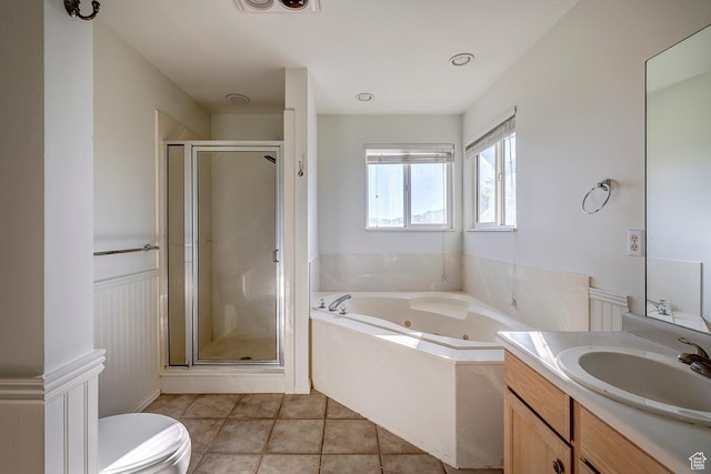 4689 W Nebo Dr S, West Jordan, UT 84088 - bathroom with a tub with jets, vanity, a stall shower, wainscoting, and tile patterned flooring