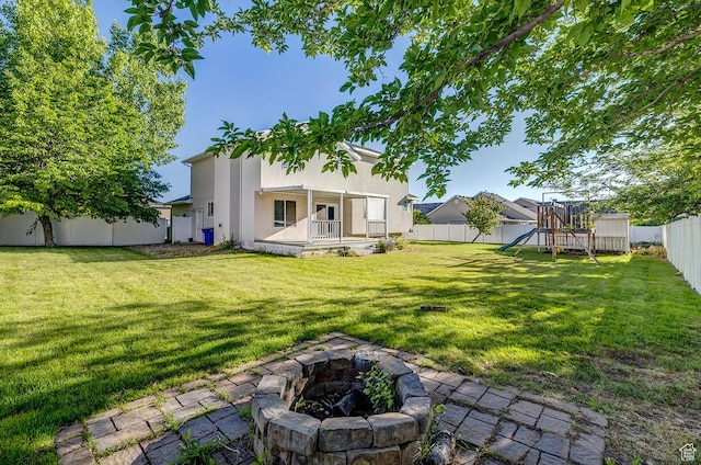 4689 W Nebo Dr S, West Jordan, UT 84088 - fenced backyard featuring a playground and a fire pit