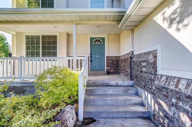 4689 W Nebo Dr S, West Jordan, UT 84088 - view of exterior entry with stucco siding and covered porch