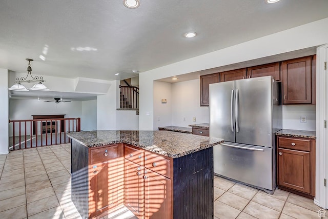 4689 W Nebo Dr S, West Jordan, UT 84088 - kitchen with freestanding refrigerator, light tile patterned floors, a ceiling fan, dark stone countertops, and recessed lighting