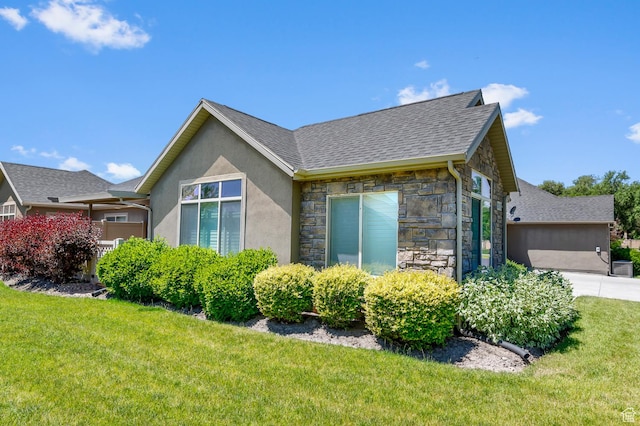 9213 S 2040 W Unit C, West Jordan, UT 84088 - view of property exterior featuring stone siding, a yard, driveway, stucco siding, and an attached garage