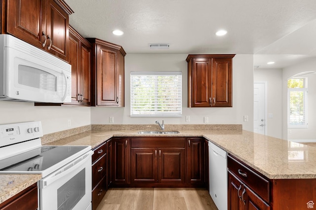 9213 S 2040 W Unit C, West Jordan, UT 84088 - kitchen with white appliances, a peninsula, light wood-style flooring, light stone countertops, and recessed lighting