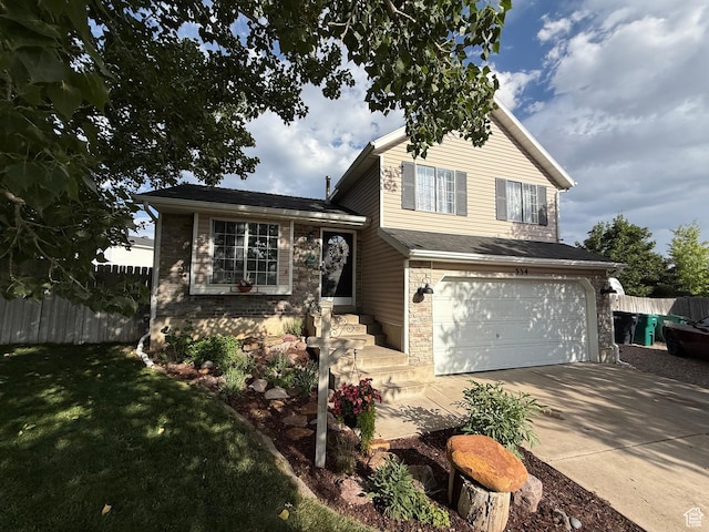 334 W 100 N, Clearfield, UT 84015 - split level home with a garage, driveway, and stone siding