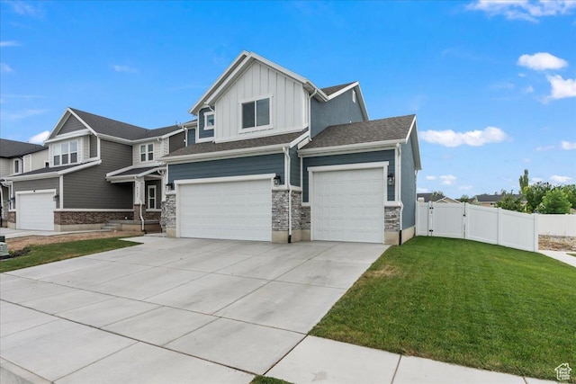 4113 S 3560 W, West Haven, UT 84401 - view of front of home with board and batten siding, a garage, a gate, driveway, and stone siding