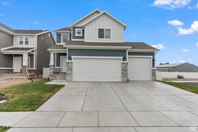 4113 S 3560 W, West Haven, UT 84401 - view of front of home featuring board and batten siding, concrete driveway, an attached garage, and stone siding
