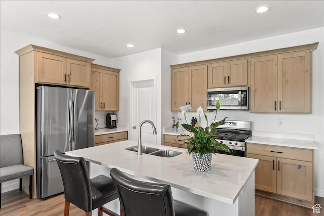 4113 S 3560 W, West Haven, UT 84401 - kitchen with stainless steel appliances, dark wood-style flooring, light countertops, an island with sink, and a breakfast bar area