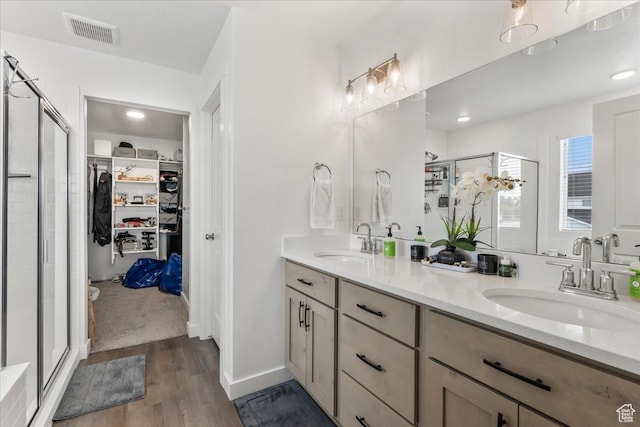 4113 S 3560 W, West Haven, UT 84401 - full bath featuring a spacious closet, double vanity, a stall shower, and wood finished floors