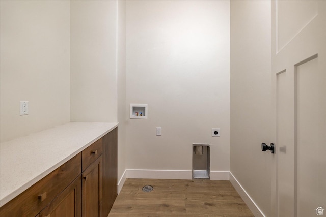 156 N Sherwood Dr, Providence, UT 84332 - laundry area with light wood-style flooring, hookup for an electric dryer, hookup for a washing machine, and cabinet space