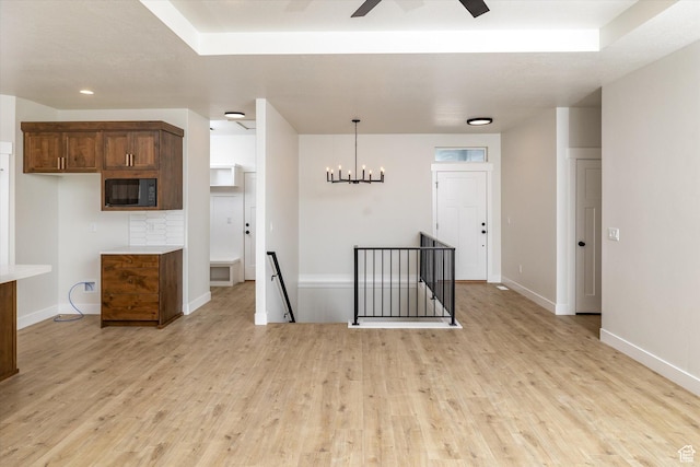 156 N Sherwood Dr, Providence, UT 84332 - empty room with light wood-style flooring, ceiling fan, and a chandelier