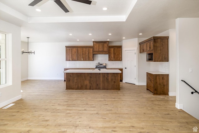 156 N Sherwood Dr, Providence, UT 84332 - kitchen featuring decorative backsplash, light countertops, ceiling fan, light wood finished floors, and recessed lighting