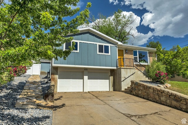 470 Hiland Rd, Ogden, UT 84404 - view of front of property featuring a garage, board and batten siding, concrete driveway, and brick siding