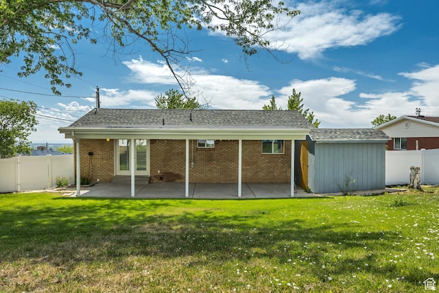 470 Hiland Rd, Ogden, UT 84404 - rear view of house featuring a patio area, a fenced backyard, brick siding, and roof with shingles
