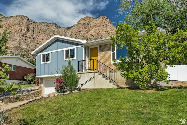 470 Hiland Rd, Ogden, UT 84404 - single story home with board and batten siding, a garage, brick siding, and a mountain view