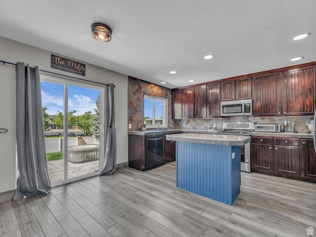 6238 W 8235 S, West Jordan, UT 84084 - kitchen featuring appliances with stainless steel finishes, light countertops, recessed lighting, plenty of natural light, and decorative backsplash
