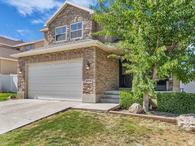 6238 W 8235 S, West Jordan, UT 84084 - view of front of house with stone siding, driveway, an attached garage, and stucco siding