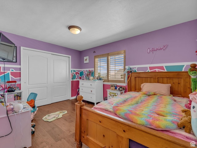 6238 W 8235 S, West Jordan, UT 84084 - bedroom featuring a closet, light wood-style floors, and a wainscoted wall