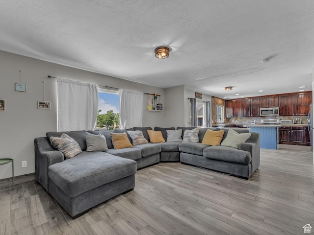 6238 W 8235 S, West Jordan, UT 84084 - living room featuring a textured ceiling and light wood finished floors