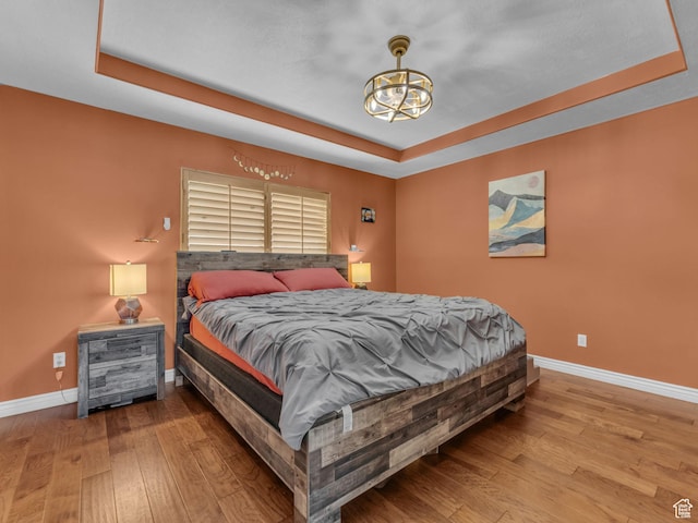 6238 W 8235 S, West Jordan, UT 84084 - bedroom featuring a tray ceiling, hardwood / wood-style flooring, and a chandelier