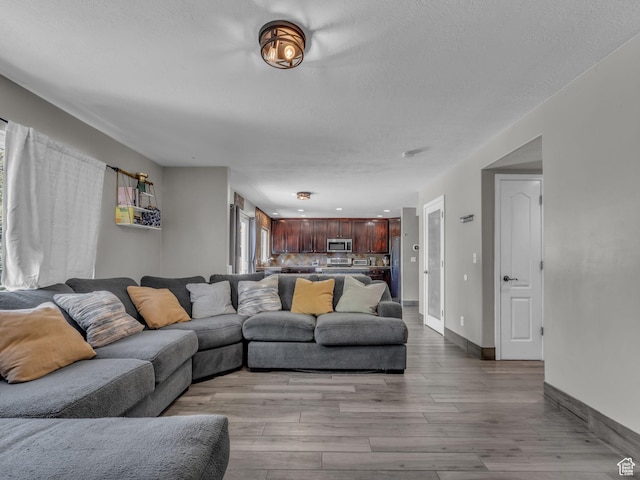 6238 W 8235 S, West Jordan, UT 84084 - living area featuring wood finished floors and a textured ceiling