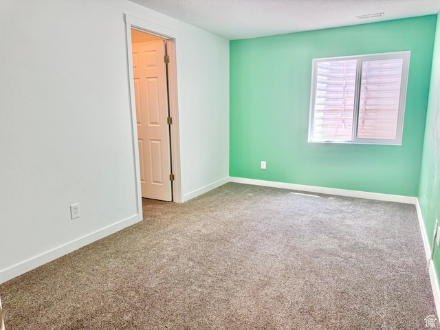 5923 W 8170 S Unit U102, West Jordan, UT 84081 - spare room featuring carpet and a textured ceiling