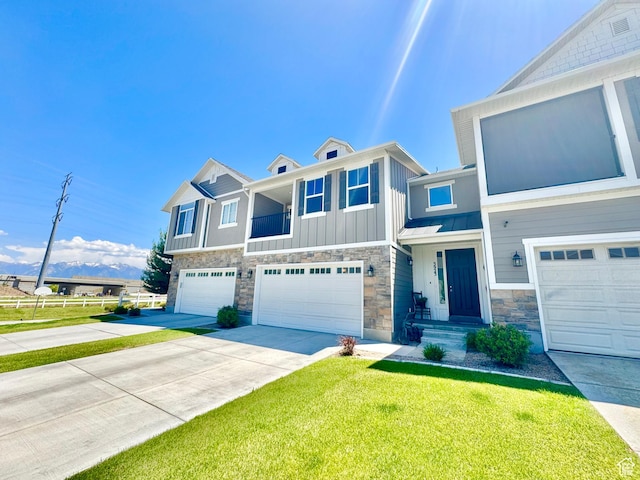 5923 W 8170 S Unit U102, West Jordan, UT 84081 - view of front of home with stone siding, an attached garage, driveway, and board and batten siding