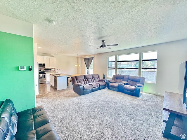 5923 W 8170 S Unit U102, West Jordan, UT 84081 - living area featuring ceiling fan, carpet flooring, and a textured ceiling