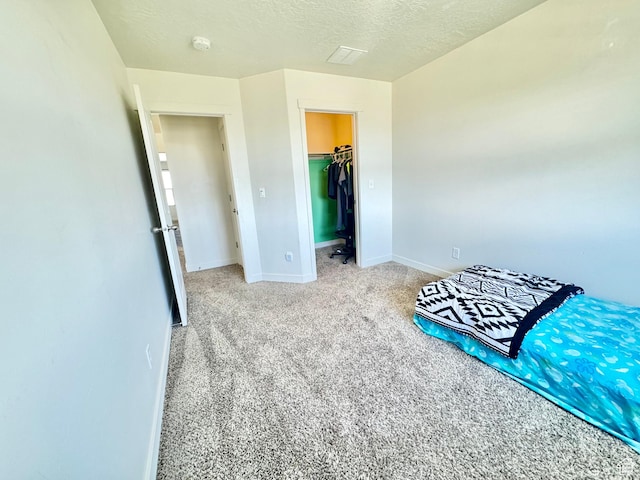 5923 W 8170 S Unit U102, West Jordan, UT 84081 - unfurnished bedroom featuring carpet floors, a textured ceiling, a closet, and a spacious closet
