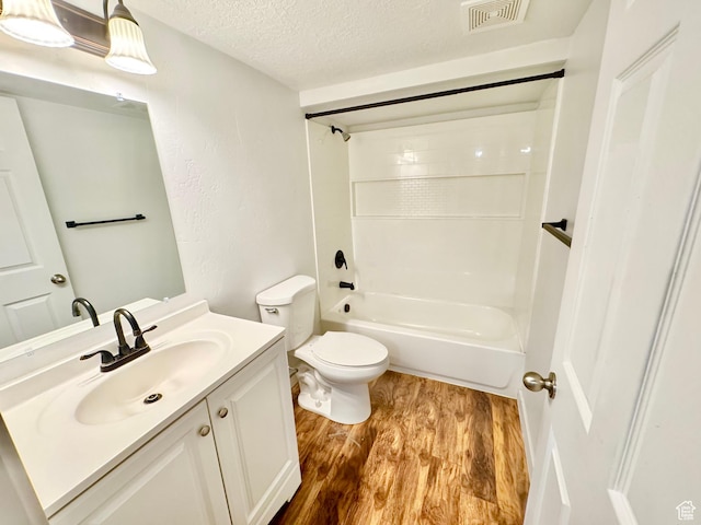 5923 W 8170 S Unit U102, West Jordan, UT 84081 - full bathroom featuring a textured ceiling, wood finished floors, vanity, and shower / tub combination
