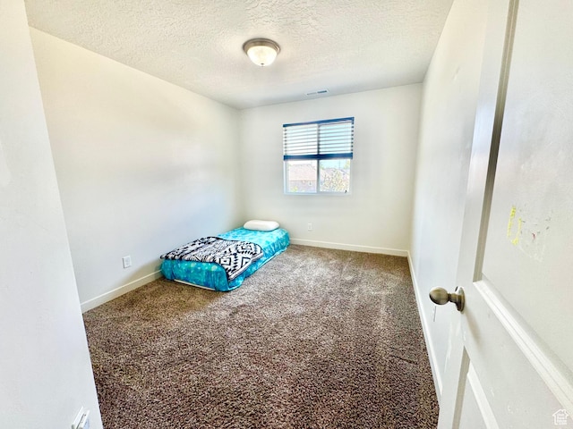 5923 W 8170 S Unit U102, West Jordan, UT 84081 - unfurnished bedroom featuring a textured ceiling and carpet floors