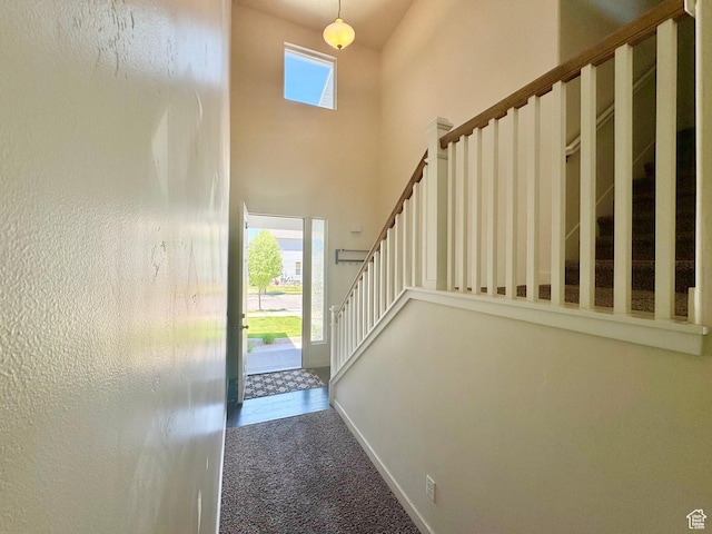 5923 W 8170 S Unit U102, West Jordan, UT 84081 - foyer with carpet flooring, stairs, and a high ceiling