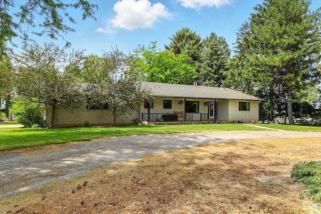12800 N 1200 E, Cove, UT 84320 - single story home featuring curved driveway, a front yard, a porch, and brick siding