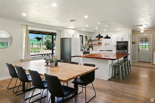 12800 N 1200 E, Cove, UT 84320 - dining space featuring dark wood-style flooring, a textured ceiling, plenty of natural light, and recessed lighting