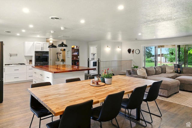 12800 N 1200 E, Cove, UT 84320 - dining area with recessed lighting, light wood-style flooring, and a textured ceiling