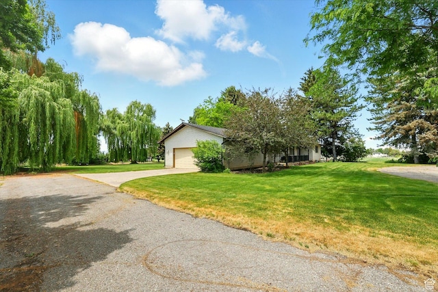 12800 N 1200 E, Cove, UT 84320 - obstructed view of property with driveway, a front yard, and an attached garage