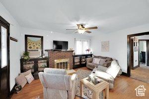 3022 S Jackson Ave E, Ogden, UT 84403 - living area featuring ceiling fan, a fireplace, and wood finished floors