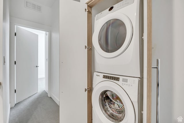 877 S 200 W Unit 212, Salt Lake City, UT 84101 - washroom with stacked washer / dryer and light carpet