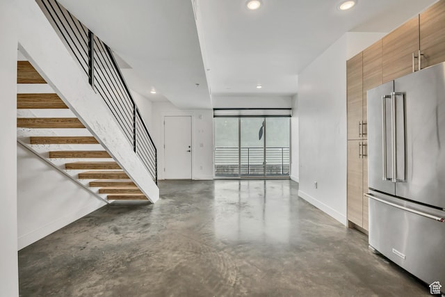 877 S 200 W Unit 212, Salt Lake City, UT 84101 - unfurnished living room with finished concrete flooring, recessed lighting, and stairway
