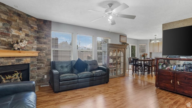 4111 S John Way W, West Valley City, UT 84120 - living room with a ceiling fan, wood finished floors, a fireplace, and a chandelier