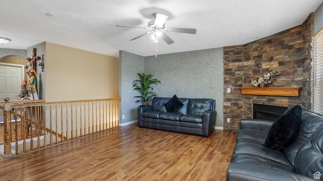 4111 S John Way W, West Valley City, UT 84120 - living area featuring a ceiling fan, wood finished floors, and a stone fireplace