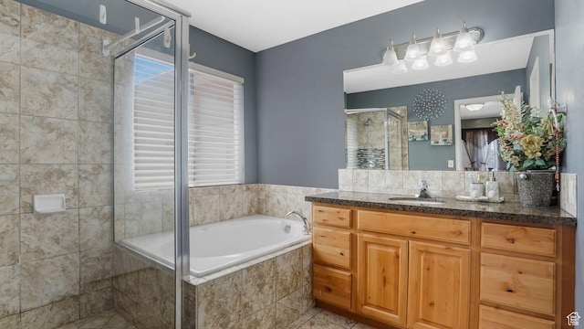 4111 S John Way W, West Valley City, UT 84120 - full bathroom with vanity, a garden tub, a stall shower, and tile patterned flooring