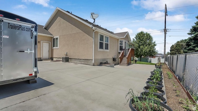 4111 S John Way W, West Valley City, UT 84120 - back of property with stucco siding, a fenced backyard, and a patio