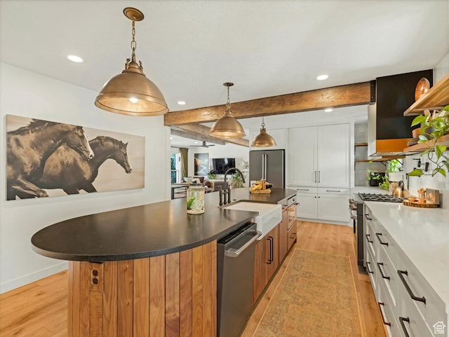 9714 S Buttonwood Dr E, Sandy, UT 84092 - kitchen featuring stainless steel appliances, light wood-style flooring, a center island with sink, white cabinetry, and beamed ceiling