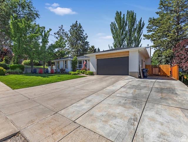 9714 S Buttonwood Dr E, Sandy, UT 84092 - view of front of home with an attached garage, concrete driveway, brick siding, and a gate