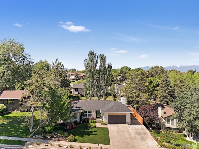 9714 S Buttonwood Dr E, Sandy, UT 84092 - view of front facade with a garage, concrete driveway, a front lawn, and a residential view