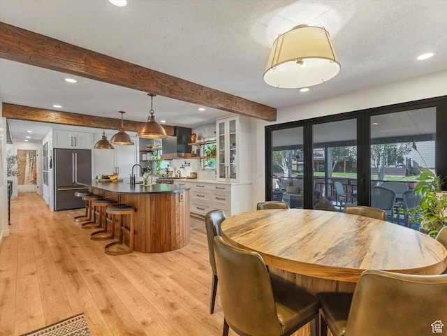 9714 S Buttonwood Dr E, Sandy, UT 84092 - dining space with beam ceiling, light wood-style floors, recessed lighting, and a textured ceiling