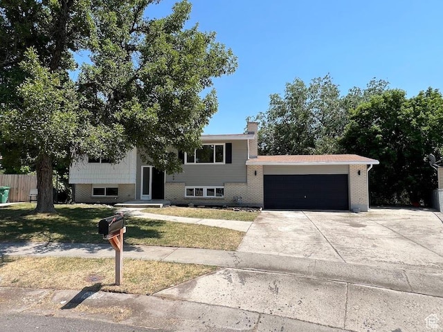 1569 E Boysenberry Cir S, Sandy, UT 84093 - view of front of home featuring an attached garage, concrete driveway, a chimney, and brick siding