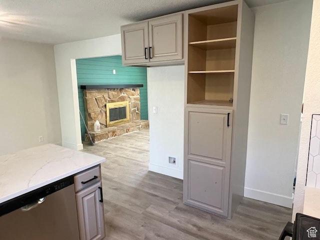 1569 E Boysenberry Cir S, Sandy, UT 84093 - kitchen with dishwasher, wood finished floors, light stone counters, and a stone fireplace